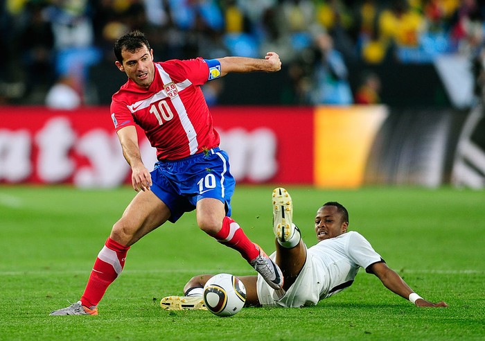 PRETORIA, SOUTH AFRICA - JUNE 13:  Dejan Stankovic of Serbia rides the tackle by Andrew Ayew of Ghana during the 2010 FIFA World Cup South Africa Group D match between Serbia and Ghana at Loftus Versfeld Stadium on June 13, 2010 in Pretoria, South Africa.  (Photo by Stuart Franklin/Getty Images)