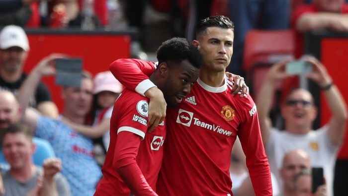 MANCHESTER, ENGLAND - APRIL 16: Cristiano Ronaldo of Manchester United celebrates with team mate Anthony Elanga after scoring their sides first goal during the Premier League match between Manchester United and Norwich City at Old Trafford on April 16, 2022 in Manchester, England. (Photo by Jan Kruger/Getty Images)