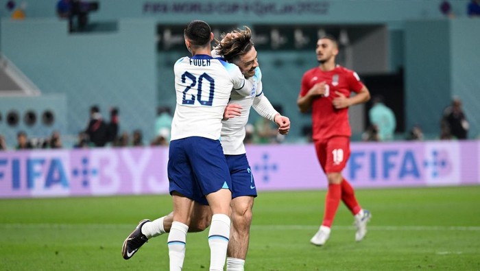 DOHA, QATAR - NOVEMBER 21: Jack Grealish celebrates with Phil Foden of England after scoring their teams sixth goal during the FIFA World Cup Qatar 2022 Group B match between England and IR Iran at Khalifa International Stadium on November 21, 2022 in Doha, Qatar. (Photo by Matthias Hangst/Getty Images)