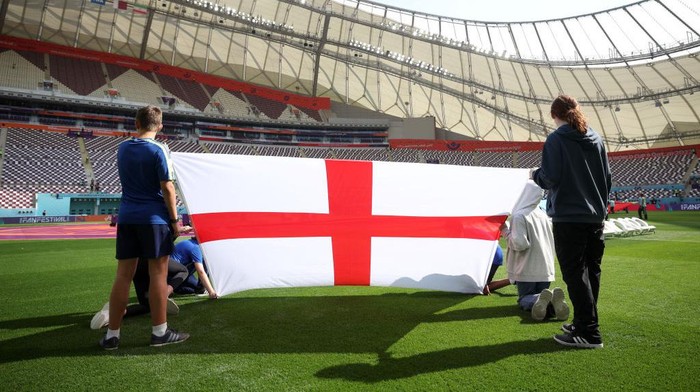 DOHA, QATAR - NOVEMBER 21: An England flag is held on the pitch prior to the FIFA World Cup Qatar 2022 Group B match between England and IR Iran at Khalifa International Stadium on November 21, 2022 in Doha, Qatar. (Photo by Eddie Keogh - The FA/The FA via Getty Images)
