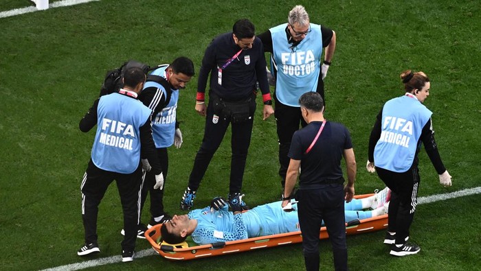 Irans goalkeeper #01 Alireza Beiranvand lies on a stretcher following a crash of heads with Irans defender #19 Majid Hosseini during the Qatar 2022 World Cup Group B football match between England and Iran at the Khalifa International Stadium in Doha on November 21, 2022. (Photo by Jewel SAMAD / AFP) (Photo by JEWEL SAMAD/AFP via Getty Images)