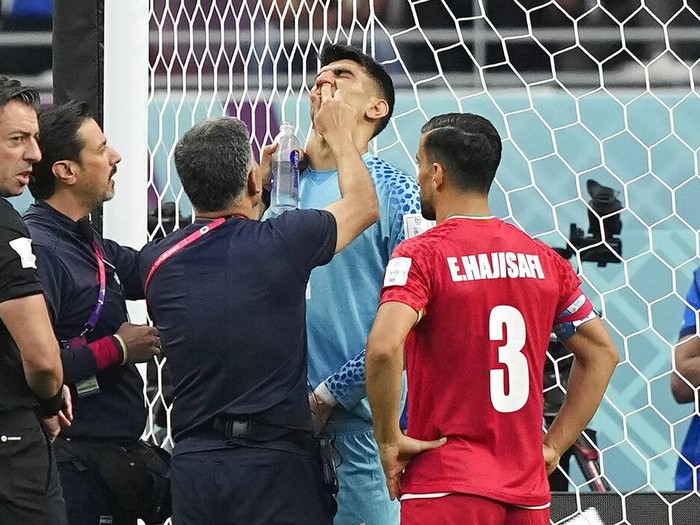 Iran's goalkeeper Alireza Beiranvand gets treatment in his nose during the World Cup group B soccer match between England and Iran at the Khalifa International Stadium in in Doha, Qatar, Monday, Nov. 21, 2022. (AP Photo/Martin Meissner)