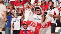 Beberapa penggemar Inggris di tribun mengenakan topeng muka Harry Maguire dan pemain-pemain Inggris lainnya sebagai simbol dukungan. (Foto: Getty Images/Marc Atkins)