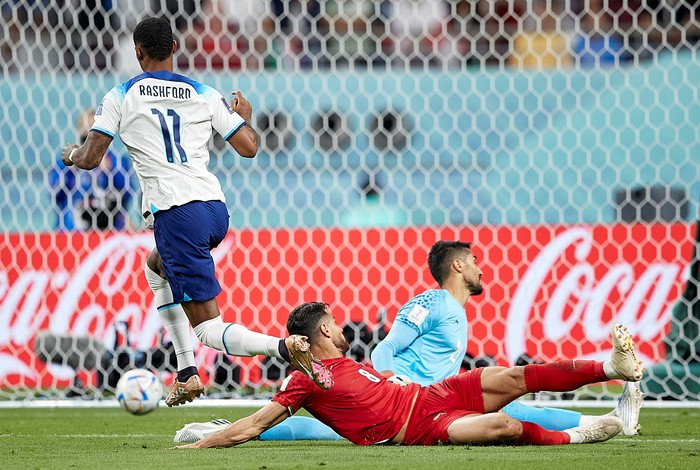 England v IR Iran: Group B - FIFA World Cup Qatar 2022
DOHA, QATAR - NOVEMBER 21: Marcus Rashford of England beats Morteza Pouraliganji and Hossein Hosseini of Iran and scores his team fifth goal during the FIFA World Cup Qatar 2022 Group B match between England and IR Iran at Khalifa International Stadium on November 21, 2022 in Doha, Qatar. (Photo by Juan Luis Diaz/Quality Sport Images/Getty Images)