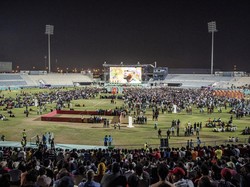 Pekerja migran menonton pertandingan Qatar vs Ekuador di Doha, Qatar, Minggu (20/11/2022). Layar raksasa dipasang di zona penggemar khusus di dekat kawasan industri itu.