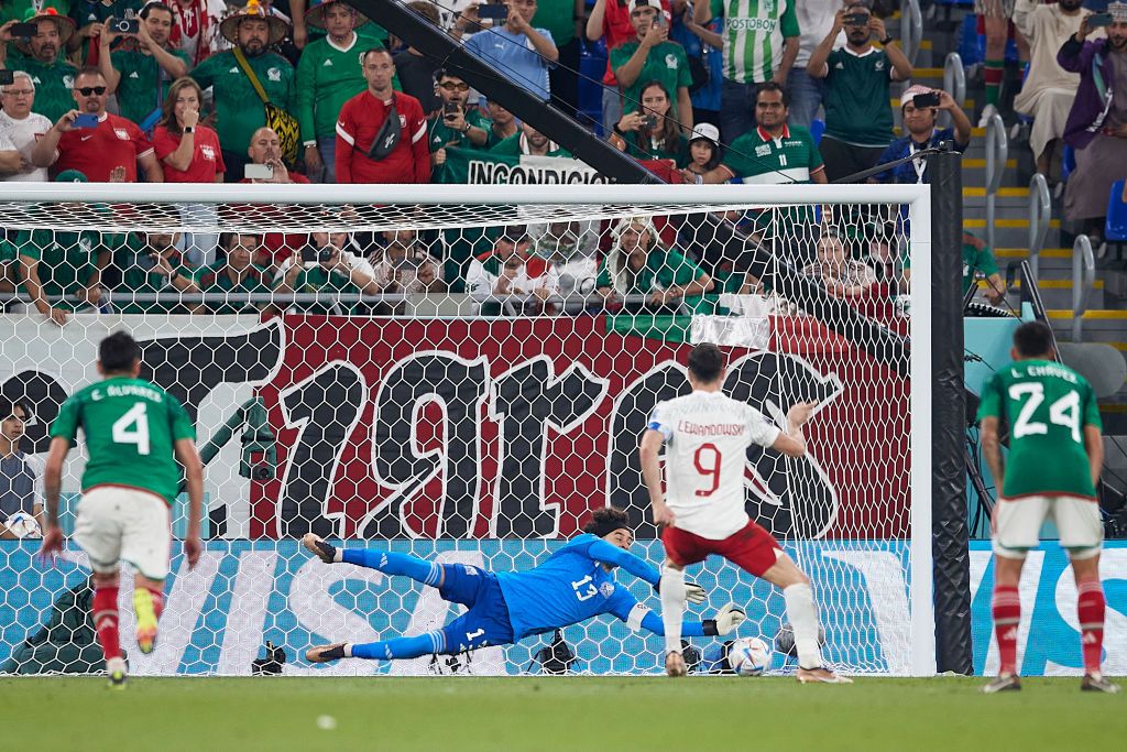 DOHA, QATAR - NOVEMBER 22:  Robert Lewandowski of Poland shoots a penalty which is saved by Guillermo Ochoa of Mexico during the FIFA World Cup Qatar 2022 Group C match between Mexico and Poland at Stadium 974 on November 22, 2022 in Doha, Qatar. (Photo by Juan Luis Diaz/Quality Sport Images/Getty Images)
