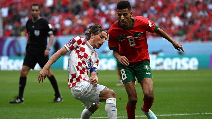 Croatias midfielder #10 Luka Modric and Moroccos midfielder #08 Azzedine Ounahi fight for the ball during the Qatar 2022 World Cup Group F football match between Morocco and Croatia at the Al-Bayt Stadium in Al Khor, north of Doha on November 23, 2022. (Photo by OZAN KOSE / AFP) (Photo by OZAN KOSE/AFP via Getty Images)