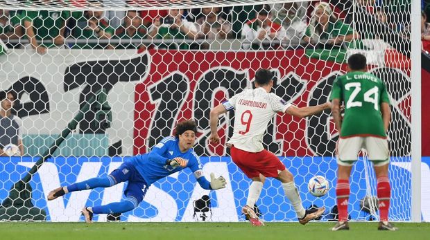 DOHA, QATAR - NOVEMBER 22: Robert Lewandowski of Poland shoots a penalty which is saved by Guillermo Ochoa of Mexico during the FIFA World Cup Qatar 2022 Group C match between Mexico and Poland at Stadium 974 on November 22, 2022 in Doha, Qatar. (Photo by Dan Mullan/Getty Images)