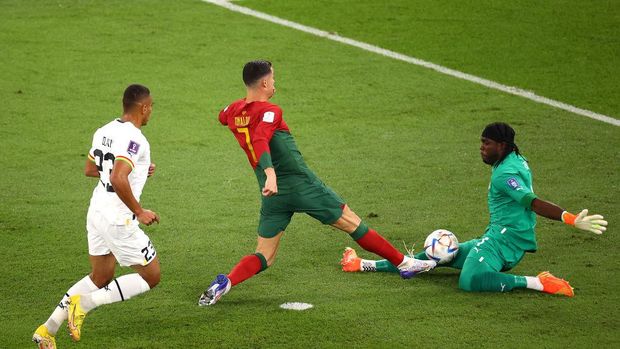 DOHA, QATAR - NOVEMBER 24: Lawrence Ati Zigi of Ghana saves an attempt by Cristiano Ronaldo of Portugal during the FIFA World Cup Qatar 2022 Group H match between Portugal and Ghana at Stadium 974 on November 24, 2022 in Doha, Qatar. (Photo by Robert Cianflone/Getty Images)