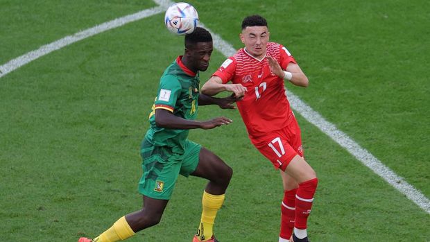 Soccer Football - FIFA World Cup Qatar 2022 - Group G - Switzerland v Cameroon - Al Janoub Stadium, Al Wakrah, Qatar - November 24, 2022 Cameroon's Samuel Oum Gouet in action with Switzerland's Ruben Vargas REUTERS/Marko Djurica