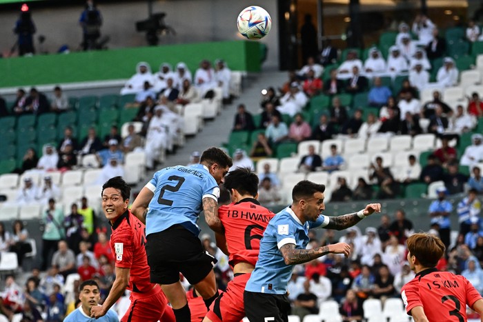 Uruguays defender #02 Jose Maria Gimenez and South Koreas midfielder #06 Hwang In-beom jump to head the ball during the Qatar 2022 World Cup Group H football match between Uruguay and South Korea at the Education City Stadium in Al-Rayyan, west of Doha on November 24, 2022. (Photo by Anne-Christine POUJOULAT / AFP) (Photo by ANNE-CHRISTINE POUJOULAT/AFP via Getty Images)