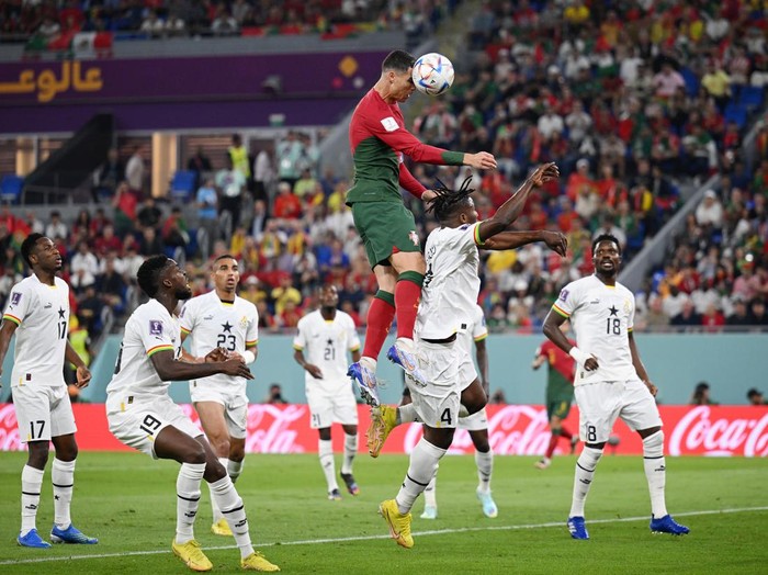 DOHA, QATAR - NOVEMBER 24: Cristiano Ronaldo of Portugal competes for a header against Mohammed Salisu of Ghana during the FIFA World Cup Qatar 2022 Group H match between Portugal and Ghana at Stadium 974 on November 24, 2022 in Doha, Qatar. (Photo by Matthias Hangst/Getty Images)