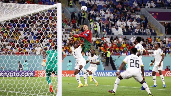Cristiano Ronaldo, Portugal, Ghana DOHA, QATAR - NOVEMBER 24: Cristiano Ronaldo of Portugal competes for a header against Mohammed Salisu of Ghana during the FIFA World Cup Qatar 2022 Group H match between Portugal and Ghana at Stadium 974 on November 24, 2022 in Doha, Qatar. (Photo by Julian Finney/Getty Images)