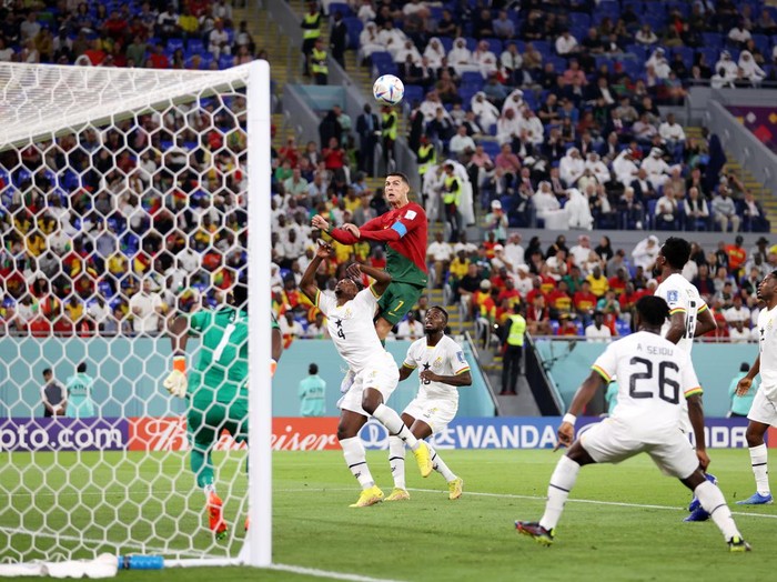 DOHA, QATAR - NOVEMBER 24: Cristiano Ronaldo of Portugal competes for a header against Mohammed Salisu of Ghana during the FIFA World Cup Qatar 2022 Group H match between Portugal and Ghana at Stadium 974 on November 24, 2022 in Doha, Qatar. (Photo by Julian Finney/Getty Images)