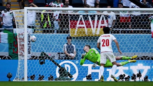 Soccer Football - FIFA World Cup Qatar 2022 - Group B - Wales v Iran - Ahmad Bin Ali Stadium, Al Rayyan, Qatar - November 25, 2022 Iran's Ali Gholizadeh shoots at goal and hits the post as Wales' Wayne Hennessey dives in an attempt to make a save REUTERS/Dylan Martinez