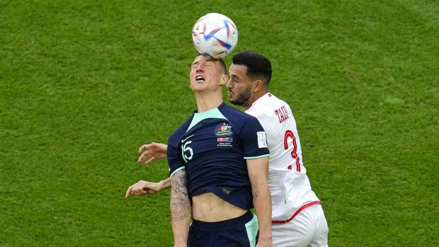 Australia's Mitchell Duke, left, and Tunisia's Montassar Talbi jump to head the ball during the World Cup group D soccer match between Tunisia and Australia at the Al Janoub Stadium in Al Wakrah, Qatar, Saturday, Nov. 26, 2022. (AP Photo/Natacha Pisarenko)