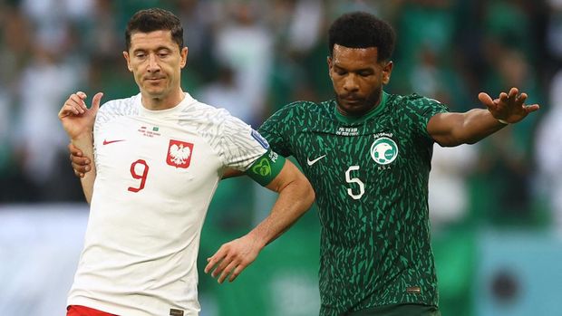 Soccer Football - FIFA World Cup Qatar 2022 - Group C - Poland v Saudi Arabia - Education City Stadium, Al Rayyan, Qatar - November 26, 2022 Poland's Robert Lewandowski in action with Saudi Arabia's Ali Al Bulayhi REUTERS/Kai Pfaffenbach