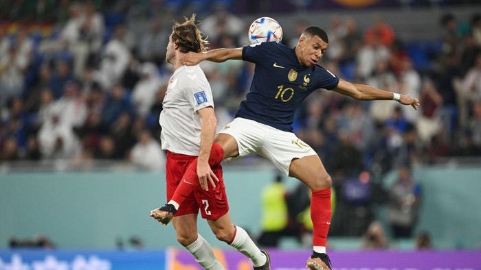 DOHA, QATAR - NOVEMBER 26: Joachim Andersen of Denmark competes for a header against Kylian Mbappe of France during the FIFA World Cup Qatar 2022 Group D match between France and Denmark at Stadium 974 on November 26, 2022 in Doha, Qatar. (Photo by Clive Mason/Getty Images)