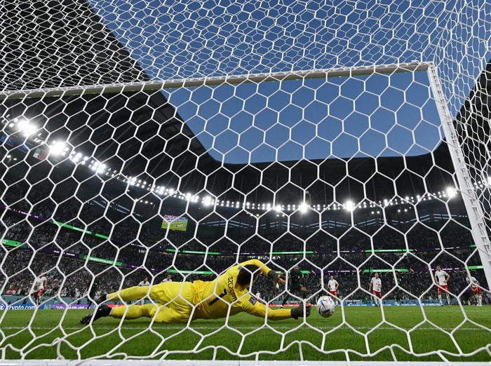 Poland's goalkeeper #01 Wojciech Szczesny stops a penalty by Saudi Arabia's midfielder #10 Salem Al-Dawsari during the Qatar 2022 World Cup Group C football match between Poland and Saudi Arabia at the Education City Stadium in Al-Rayyan, west of Doha on November 26, 2022. (Photo by ANDREJ ISAKOVIC / AFP) (Photo by ANDREJ ISAKOVIC/AFP via Getty Images)