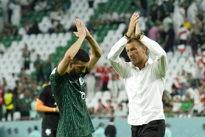 Saudi Arabias Abdulelha Al-Malki, left, and Saudi Arabias head coach Herve Renard applaud fans at the end of the World Cup group C soccer match between Poland and Saudi Arabia, at the Education City Stadium in Al Rayyan , Qatar, Saturday, Nov. 26, 2022. (AP Photo/Francisco Seco)