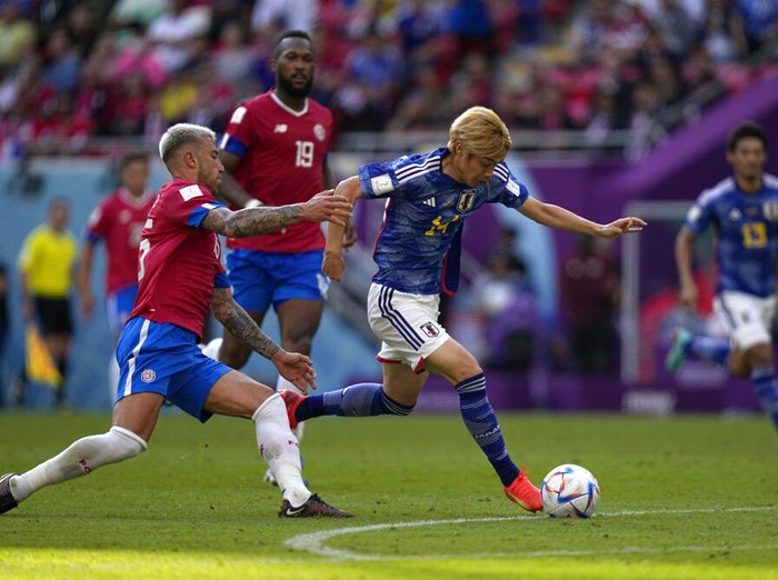 Japan's Junya Ito, right, duels for the ball with Costa Rica's Francisco Calvo during the World Cup, group E soccer match between Japan and Costa Rica, at the Ahmad Bin Ali Stadium in Al Rayyan , Qatar, Sunday, Nov. 27, 2022. (AP Photo/Ariel Schalit)