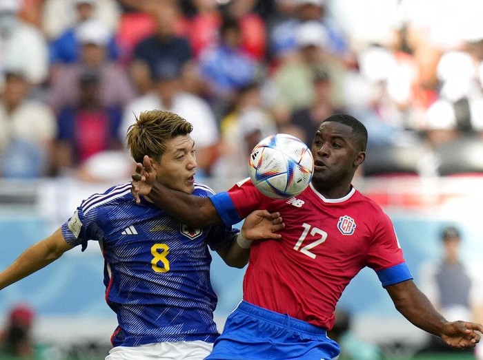 Costa Rica's Joel Campbell, right, and Japan's Ritsu Doan challenge for the ball during the World Cup, group E soccer match between Japan and Costa Rica, at the Ahmad Bin Ali Stadium in Al Rayyan , Qatar, Sunday, Nov. 27, 2022. (AP Photo/Francisco Seco)