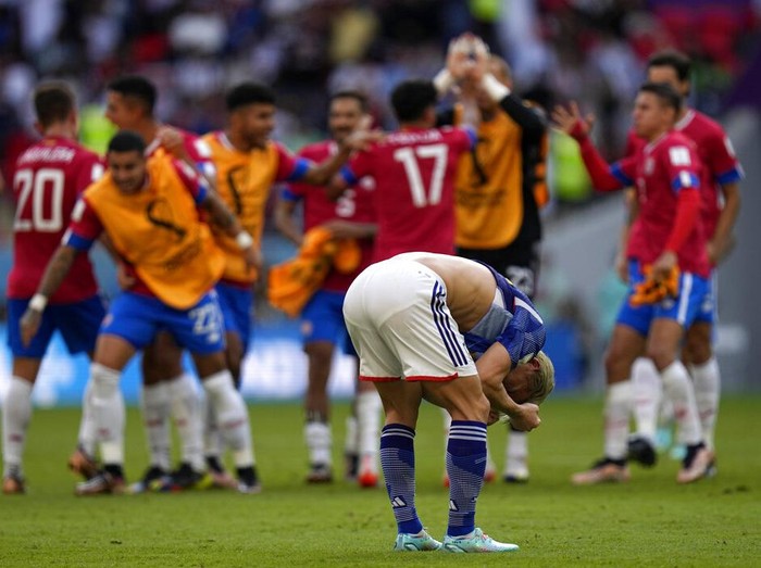 Japan's Takuma Asano, foreground, reacts at the end of the World Cup, group E soccer match between Japan and Costa Rica, at the Ahmad Bin Ali Stadium in Al Rayyan , Qatar, Sunday, Nov. 27, 2022. Costa Rica won 1-0. (AP Photo/Ariel Schalit)