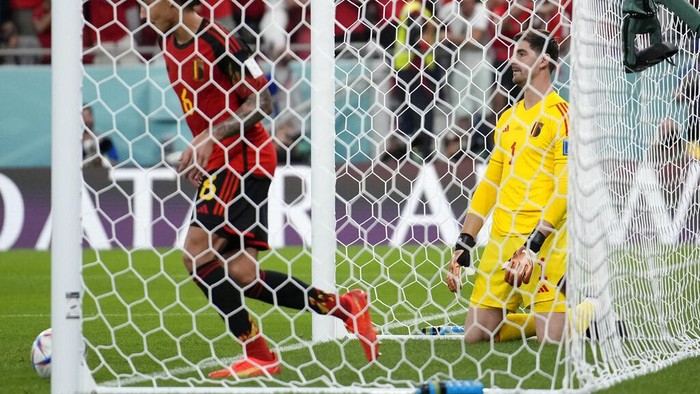 Belgium's goalkeeper Thibaut Courtois kneels on the ground after Morocco's Abdelhamid Sabiri scored his side's opening goal during the World Cup group F soccer match between Belgium and Morocco, at the Al Thumama Stadium in Doha, Qatar, Sunday, Nov. 27, 2022. (AP Photo/Christophe Ena)