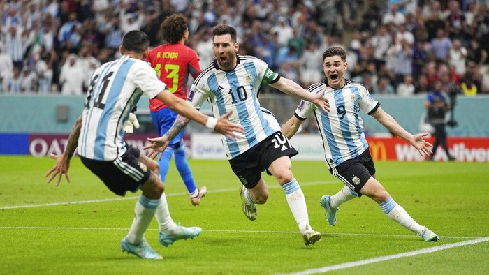 Argentina's Lionel Messi celebrates with teammates after scoring his side's first goal during the World Cup group C soccer match between Argentina and Mexico at the Lusail Stadium in Lusail, Qatar, Saturday, Nov. 26, 2022. (AP Photo/Ariel Schalit)