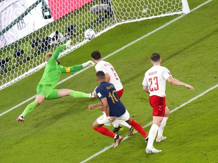 France's Kylian Mbappe, center left, scores his side's opening goal, during the World Cup group D soccer match between France and Denmark, at the Stadium 974 in Doha, Qatar, Saturday, Nov. 26, 2022.. (AP Photo/Alessandra Tarantino)