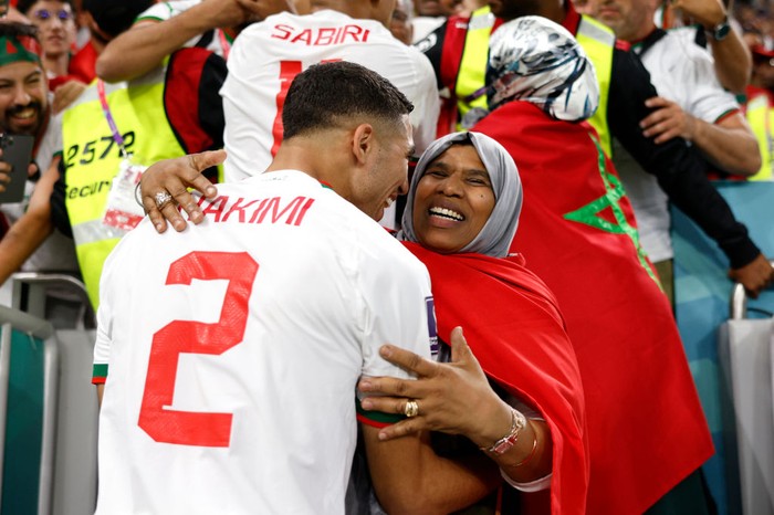 DOHA, QATAR - NOVEMBER 27: Achraf Hakimi of Morocco celebrates after his sides 2-0 victory with family after the FIFA World Cup Qatar 2022 Group F match between Belgium and Morocco at Al Thumama Stadium on November 27, 2022 in Doha, Qatar. (Photo by Adam Pretty - FIFA/FIFA via Getty Images)