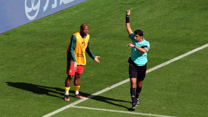 Cameroon substitute Christian Bassogog is shown a yellow card by referee Mohammed Abdulla after coming onto the pitch to celebrate their opening goal during the FIFA World Cup Group G match at the Al Janoub Stadium in Al Wakrah, Qatar. Picture date: Monday November 28, 2022. (Photo by Nick Potts/PA Images via Getty Images)