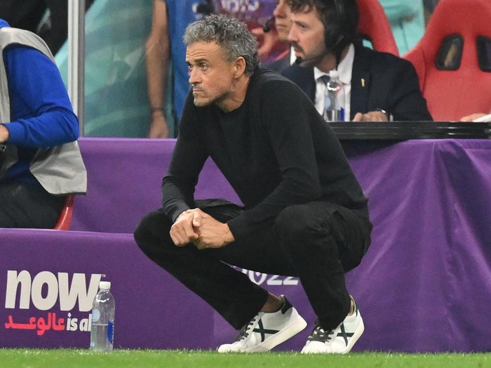 Spain's coach #00 Luis Enrique crouches during the Qatar 2022 World Cup Group E football match between Spain and Germany at the Al-Bayt Stadium in Al Khor, north of Doha on November 27, 2022. (Photo by Glyn KIRK / AFP) (Photo by GLYN KIRK/AFP via Getty Images)