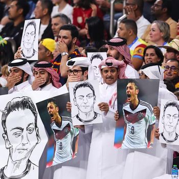 AL KHOR, QATAR - NOVEMBER 27: Local fans holding pictures and posters of Mesut Ozil during the FIFA World Cup Qatar 2022 Group E match between Spain and Germany at Al Bayt Stadium on November 27, 2022 in Al Khor, Qatar. (Photo by Robbie Jay Barratt - AMA/Getty Images)