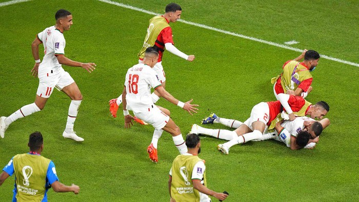 Moroccos Zakaria Aboukhlal celebrates with his teammates after scoring his sides second goal during the World Cup group F soccer match between Belgium and Morocco, at the Al Thumama Stadium in Doha, Qatar, Sunday, Nov. 27, 2022. (AP Photo/Pavel Golovkin)