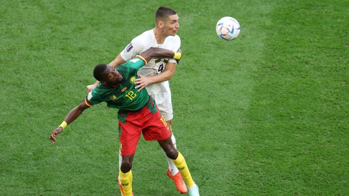 AL WAKRAH, QATAR - NOVEMBER 28: Karl Toko Ekambi of Cameroon competes for a header against Nikola Milenkovic of Serbia during the FIFA World Cup Qatar 2022 Group G match between Cameroon and Serbia at Al Janoub Stadium on November 28, 2022 in Al Wakrah, Qatar. (Photo by Francois Nel/Getty Images)