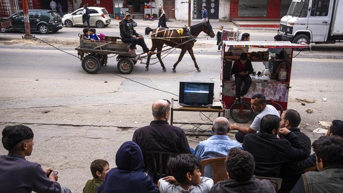 Begini Semarak Piala Dunia 2022 di Palestina Palestinians watch the live broadcast of the World Cup group H soccer match between South Korea and Ghana played in Qatar, in the street in Gaza City, Monday, Nov. 28, 2022. (AP Photo/Fatima Shbair)