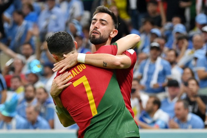 LUSAIL CITY, QATAR - NOVEMBER 28: Bruno Fernandes of Portugal celebrates scoring his sides first goal with his teammate Cristiano Ronaldo during the FIFA World Cup Qatar 2022 Group H match between Portugal and Uruguay at Lusail Stadium on November 28, 2022 in Lusail City, Qatar. (Photo by Justin Setterfield/Getty Images)