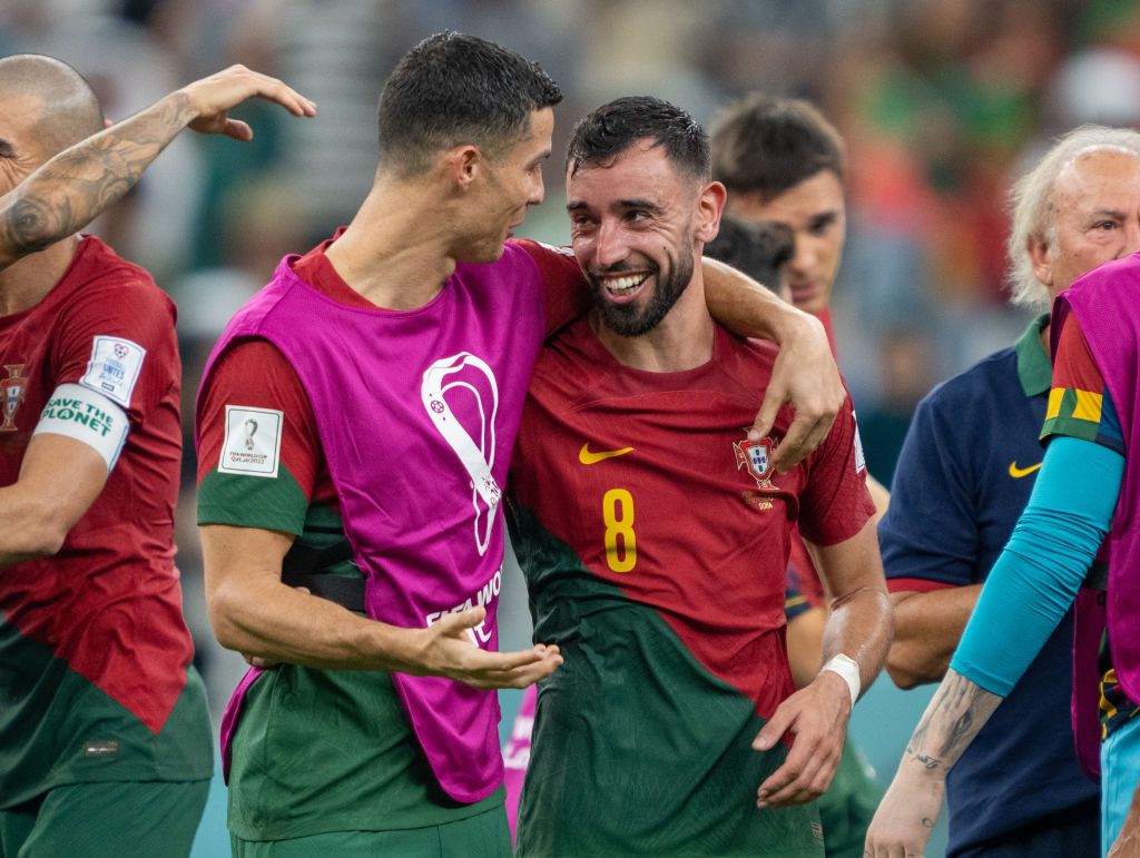 LUSAIL CITY, QATAR - NOVEMBER 28: Bruno Fernandes of Portugal celebrates scoring his side's first goal with his teammate Cristiano Ronaldo during the FIFA World Cup Qatar 2022 Group H match between Portugal and Uruguay at Lusail Stadium on November 28, 2022 in Lusail City, Qatar. (Photo by Justin Setterfield/Getty Images)