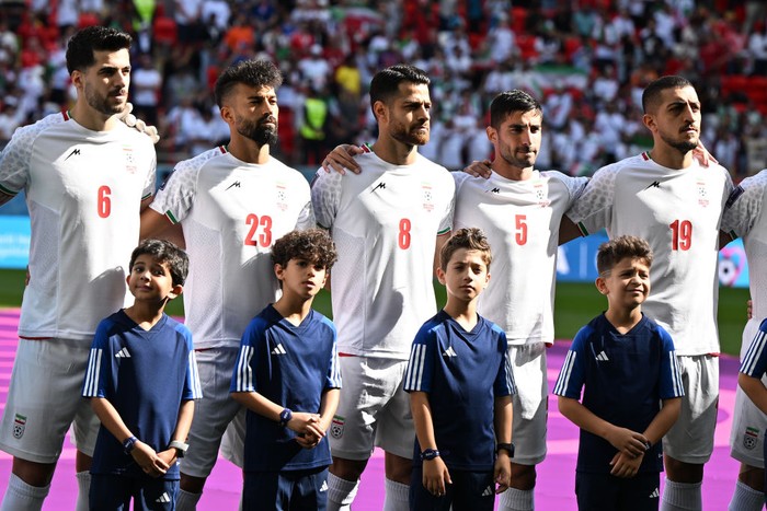 25 November 2022, Qatar, Al-Rajjan: Soccer, 2022 World Cup in Qatar, Wales - Iran, preliminary round, Group B, match day 2 at Ahmad bin Ali Stadium in Al-Rajjan, Irans Saeid Ezatolahi (l-r), Ramin Rezaeian, Morteza Pouraliganji, Milad Mohammadi and Majid Hosseini stand next to each other during the national anthem. Photo: Federico Gambarini/dpa (Photo by Federico Gambarini/picture alliance via Getty Images)