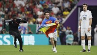 Pria itu sempat berada di lapangan selama paruh kedua pertandingan antara Portugal dan Uruguay sebelum dikawal oleh petugas keamanan. Dua petugas keamanan menangkap pria itu di tengah lapangan. (Richard Sellers/Getty Images)  
