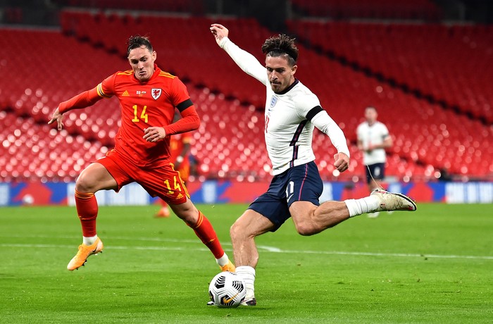 Englands Jack Grealish (right) and Wales Connor Roberts battle for the ball during the international friendly match at Wembley Stadium, London. (Photo by Glyn Kirk/PA Images via Getty Images)