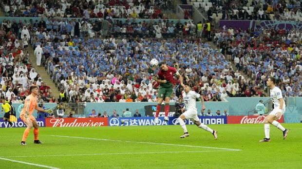 Portugal's Cristiano Ronaldo scores his side's opening goal during the World Cup group H soccer match between Portugal and Uruguay, at the Lusail Stadium in Lusail, Qatar, Monday, Nov. 28, 2022. (AP Photo/Themba Hadebe)