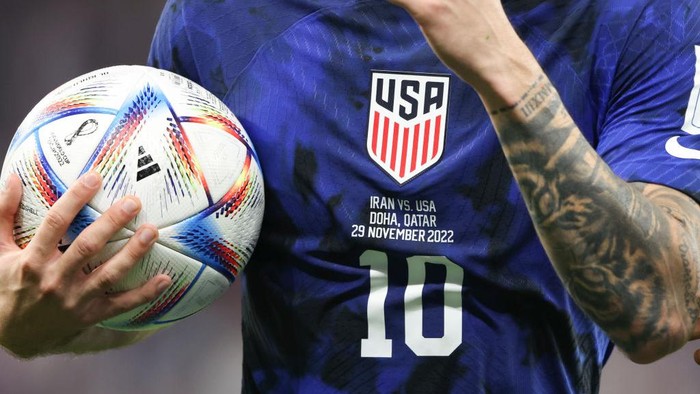 DOHA, QATAR - NOVEMBER 29: Close up detail of the shirt of Christian Pulisic of United States of America and the Adidas AlRihla match ball during the FIFA World Cup Qatar 2022 Group B match between IR Iran and USA at Al Thumama Stadium on November 29, 2022 in Doha, Qatar. (Photo by Matthew Ashton - AMA/Getty Images)
