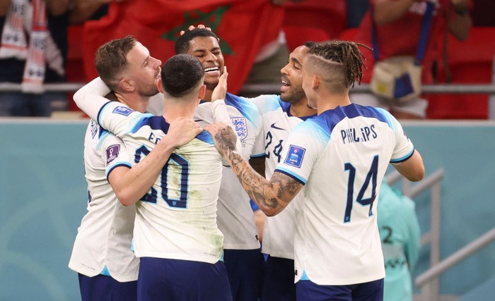 DOHA, QATAR - NOVEMBER 29: Marcus Rashford of England celebrates his second goal with teammates during the FIFA World Cup Qatar 2022 Group B match between Wales and England at Ahmad Bin Ali Stadium on November 29, 2022 in Doha, Qatar. (Photo by Jean Catuffe/Getty Images)