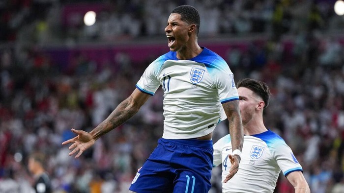 Englands Marcus Rashford celebrates after scoring the opening goal during the World Cup group B soccer match between England and Wales, at the Ahmad Bin Ali Stadium in Al Rayyan , Qatar, Tuesday, Nov. 29, 2022. (AP Photo/Frank Augstein)