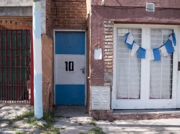 Artists Marlene Zuriaga and Lisandro Urteaga finish the details of a mural depicting Argentine football star Lionel Messi in his childhood home in Rosario, Argentina, on November 26, 2022. (Photo by MARCELO MANERA / AFP) (Photo by MARCELO MANERA/AFP via Getty Images)