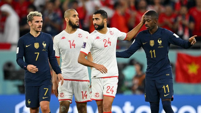 1245242653 AL RAYYAN, QATAR - NOVEMBER 30: Antoine Griezmann of France helps a dejected Wajdi Kechrida of Tunisia to his feet during the FIFA World Cup Qatar 2022 Group D match between Tunisia and France at Education City Stadium on November 30, 2022 in Al Rayyan, Qatar. (Photo by James Williamson - AMA/Getty Images)