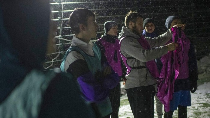 Men take part in a soccer game during a blackout in Irpin, Kyiv region, Ukraine, Tuesday, Nov. 29, 2022. For soccer lovers in Ukraine, Russia's invasion and the devastation it has wrought have created uncertainties about both playing the sport and watching it. For Ukrainians these days, soccer trails well behind mere survival in the order of priorities. (AP Photo/Andrew Kravchenko)