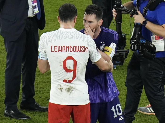 Poland's Robert Lewandowski, left, interacts with Argentina's Lionel Messi at the end of the World Cup group C soccer match between Poland and Argentina at the Stadium 974 in Doha, Qatar, Wednesday, Nov. 30, 2022. (AP Photo/Hassan Ammar)
